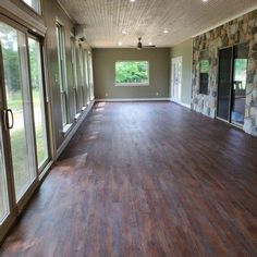 an empty room with hard wood floors and large sliding glass doors leading to the outside