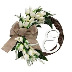 a wreath with white flowers and the number 3 on it is decorated with greenery