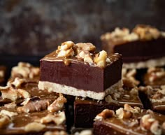 pieces of chocolate fudge cake with walnuts on top