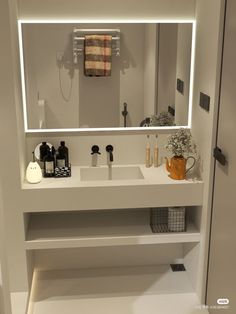 a bathroom with a sink, mirror and soap dispenser on the counter