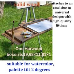 an easel sitting on top of a wooden table in the grass next to a sign that says solid wood