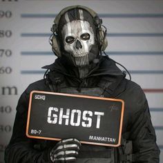 a man in a skeleton mask holding a sign that reads ghost manhattan on it's chest