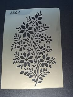 a decorative stencil is displayed on a table with a black and white background