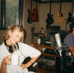 two people in a recording studio with headphones on