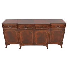 an old wooden sideboard with three drawers and two doors on the front, against a white background