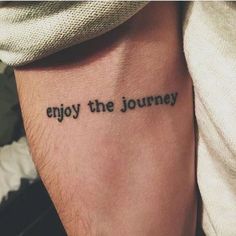 a tattoo saying enjoy the journey on someone's arm