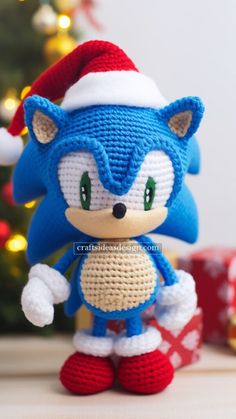 a crocheted toy sonic the hedgehog is posed in front of a christmas tree