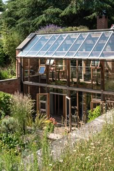 a house with a glass roof surrounded by greenery