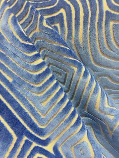 an abstract blue and yellow design on a piece of cloth or material that looks like something out of space