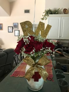 a vase filled with red roses and baby's breath on top of a table