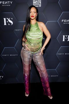 an image of a woman posing on the red carpet in front of a black background