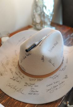 a white hat with writing on it sitting on top of a table