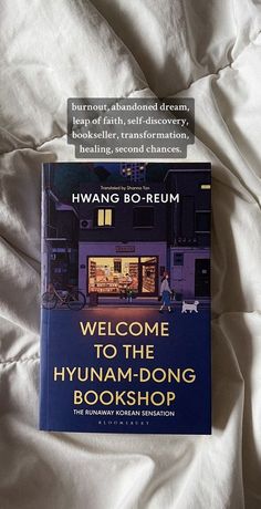 the book welcome to the hyanam - dong bookshop is laying on a bed