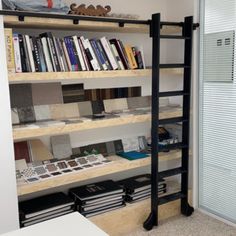 a bookshelf filled with lots of books next to a sliding glass door in a room