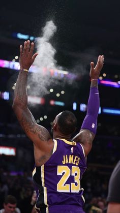 the lakers's lebron james dunks the ball in front of his teammate