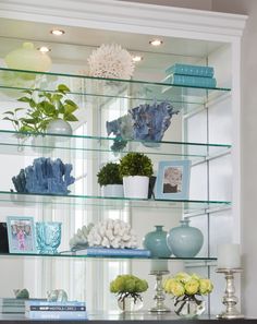 the shelves are filled with vases and other decorative items, including flowers on them