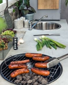 hot dogs are being cooked on the grill