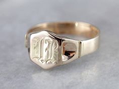 The engraving on this vintage signet ring was so well done, we opted to leave it be, and hope that we found someone with an initial "IB" who loves it as much as we do! Signet rings have a long history. Originally carved with a Family Crest, they were used to seal letters and documents by embossing the crest in wax. Over time they have evolved into day to day jewelry, which can be engraved with any crest, monogram or initial one desires. Metal: 14K Rose and Yellow Gold Top Measurements: 11 x 12 m Signet Ring Gold, Family Crest Rings, Yellow Gold Sapphire Ring, Crest Monogram, Ring Initial, Signet Ring Men, Signet Rings, Top Measurements, Vintage Monogram