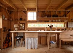 a kitchen area with wooden walls and flooring