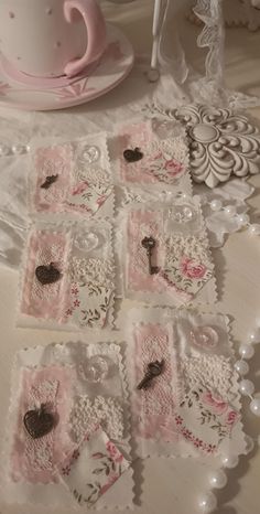 lace doily with hearts on them sitting on a table next to a cup and saucer