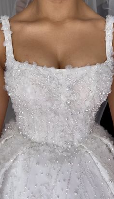 a woman in a white wedding dress is posing for the camera