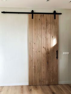 an empty room with wooden doors and white walls