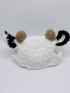 a crocheted sheep hat with horns on it