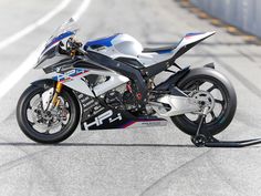 a white and blue motorcycle parked on the street