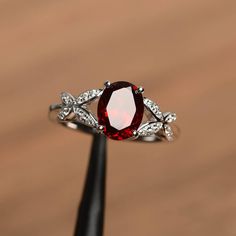 It is natural garnet ring. The main stone is 7 mm*9 mm oval cut.weight about 2.33 carats. The basic metal is sterling silver and plated with rhodium. To change the metal to a solid gold (white/rose) or platinum is also available, please ask for a quotation if you want. You can also go to my shop Home for more elegant rings: https://www.etsy.com/shop/godjewelry?ref=hdr_shop_menu garnet is January birthstone . More garnet rings: https://www.etsy.com/shop/godjewelry?section_id=20709242 Customizatio Elegant Oval Garnet Birthstone Ring, Silver Oval Ring With Lab-created Ruby, Silver Oval Lab-created Ruby Ring, Silver Oval Garnet Birthstone Ring, Oval Garnet Ring In Silver, Oval Silver Garnet Birthstone Ring, Oval Silver Ruby Promise Ring, Oval Garnet Birthstone Ring In Silver, Oval Garnet White Gold Jewelry