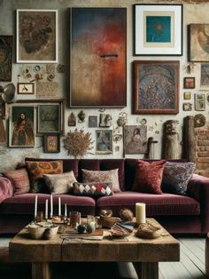 a living room filled with furniture and pictures on the wall next to a coffee table