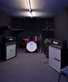 an empty room with guitars and amps in it