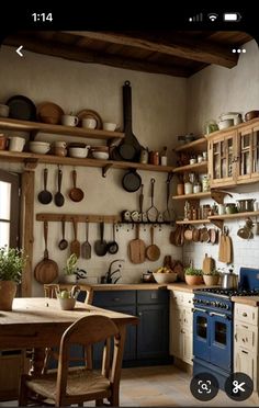 a kitchen filled with lots of wooden furniture and pots on top of the stoves