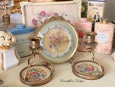 an antique clock and other items on a table