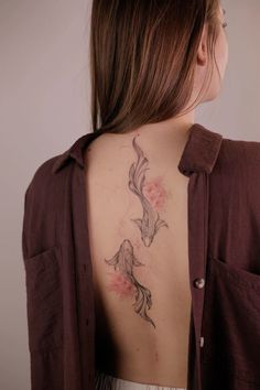 a woman with a tattoo on her back