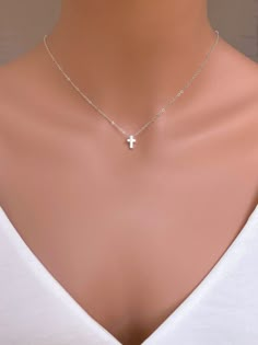 "Sterling Silver Cross Bead. A simple and classic cross shaped bead made in solid sterling silver. String this petite bead onto a finished chain for an easy and sweet necklace. The model is wearing 16\", please note the necklace length can be slightly different depend on your weight and high... Use for everyday and comfort wearing... It made of ... -9x2mm Sterling Silver Cross bead pendent attaches onto  -Sterling silver  chain14\",  16\" or 18\" or 20\" end to end spring claw, -it come with sma Silver Cross Pendant Jewelry For First Communion, Sterling Silver Cross Pendant For First Communion, Simple Cross Jewelry For Gifts, Minimalist Cross Jewelry For First Communion, Minimalist Cross Jewelry For Baptism, Elegant Silver Cross Necklace For Baptism, Silver Classic Jewelry For Baptism, Classic Silver Jewelry For Baptism, Silver Cross Necklace For Confirmation