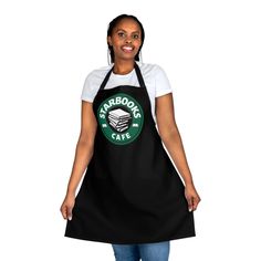 a woman wearing an apron with the words starbucks's cafe on it, smiling