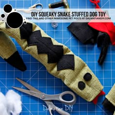 scissors and other crafting supplies laid out on a cutting board with text that reads diy souvenary snake stuffed dog toy