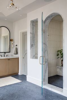 a bathroom with two sinks and a large mirror on the wall next to a walk in shower