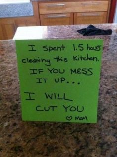 a green sign sitting on top of a kitchen counter