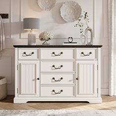 a white dresser with black top and drawers