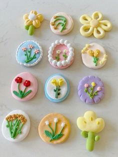 there are many different types of buttons on the table together, including flowers and leaves