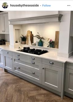 an image of a kitchen setting with grey cabinets and white counter tops on instagram