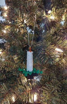 an ornament hanging from the top of a christmas tree