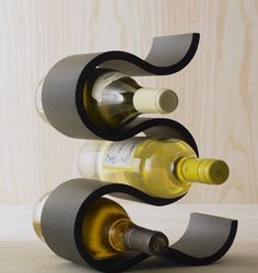 three bottles of wine are stacked on top of each other in the shape of a spiral