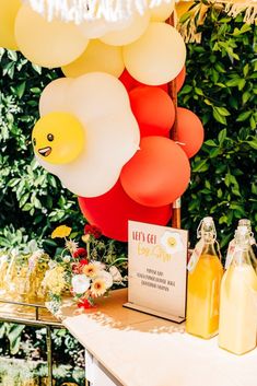 a table topped with balloons and drinks