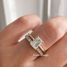 a woman's hand with a diamond ring on it