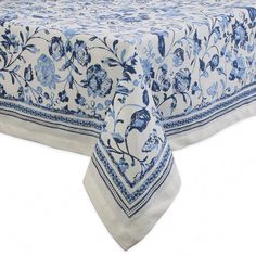 a blue and white table cloth with flowers on it