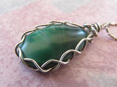 "CHAIN NOT INCLUDED, SORRY. Used in photos for reference only. PLEASE READ COMPLETE DESCRIPTION BEFORE BUYING!! Sterling Silver Wire Wrapped Green Malachite Gemstone Pendant Handmade Crystal Necklace featuring a Freeform, Natural Tumble Polished Semiprecious Mineral This pendant features a bold green, freeform shape, tumble polished Malachite gemstone, with a dramatic, elegant braid mount wrap in sterling silver wire, designed to showcase the beauty of the stone. This Malachite stone is a beauti Easy Wire Wrapping Stones, Rock Polishing, Wrapping Crystals, Polished Rocks, Handmade Crystal Necklace, Quartz Crystal Jewelry, Wire Wrapped Stone Jewelry, Wire Wrapped Gemstones Pendant, Wire Wrap Jewelry Designs