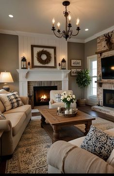 a living room filled with furniture and a fire place under a chandelier in front of a fireplace