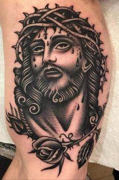 a man's leg with a tattoo on it that has an image of jesus